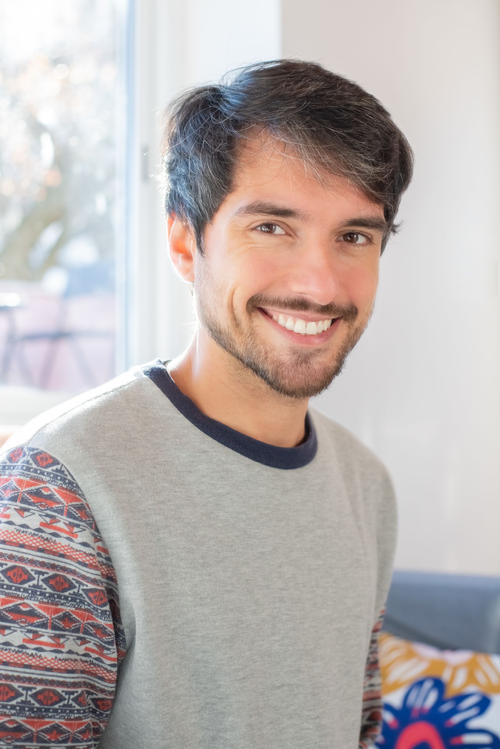 Portrait of a person with a confident, natural smile